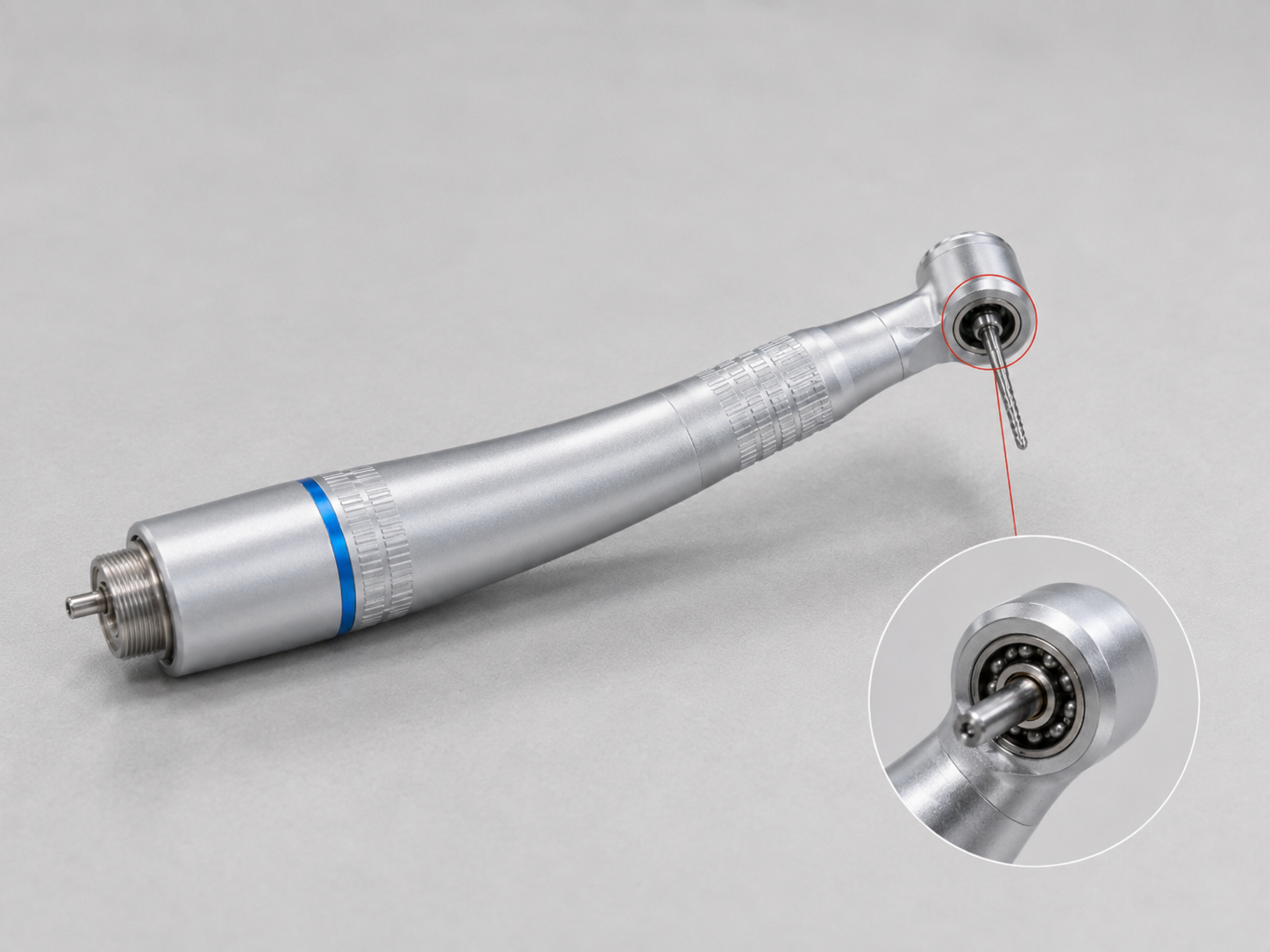 Dental handpiece with a highlighted rotary head bearing and internal close-up